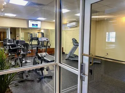 a gym with several exercise bikes in a room at Cozy Ski in out Cabin in Berkshire Resort in Hancock