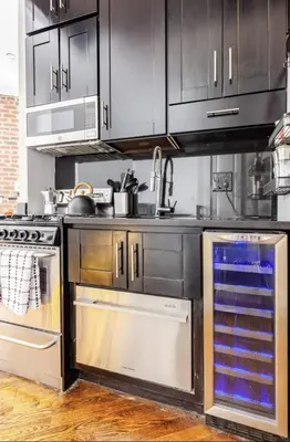 a kitchen with stainless steel cabinets and a stove at Private Room at a 3 bedroom Apt at the heart of East Village - shared apartment in New York