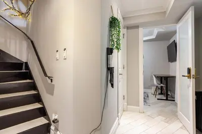 a hallway with a staircase with a plant on the wall at Lovely Room at 3 bedroom Apt at the heart of East Village in New York