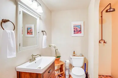 a bathroom with a sink and a toilet and a window at Pet-Friendly Hopewell Junction Home with Pool in Hopewell Junction