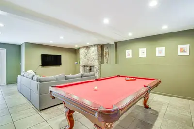 a living room with a pool table and a couch at Pet-Friendly Hopewell Junction Home with Pool in Hopewell Junction