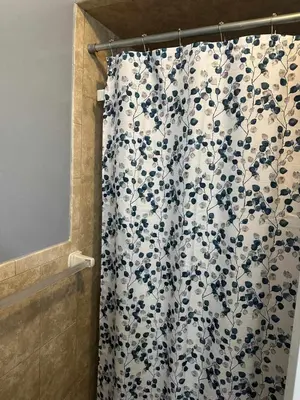 a bathroom shower with a blue and white shower curtain at Divine Villa and Resorts 67 Sherman 5mins to EWR Airport and 4mins to Penn Station Newark, 20Mins to New York in Newark