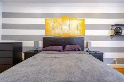 a bedroom with a large bed with two night stands at 2 Large Bedrooms In Rego Park in Rego Park