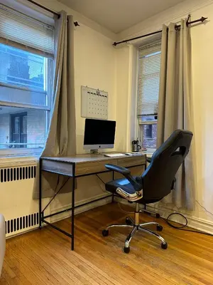 a desk with a computer and a chair in a room at 2 Large Bedrooms In Rego Park in Rego Park