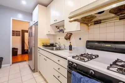 a kitchen with a stove and a sink at 2 Large Bedrooms In Rego Park in Rego Park