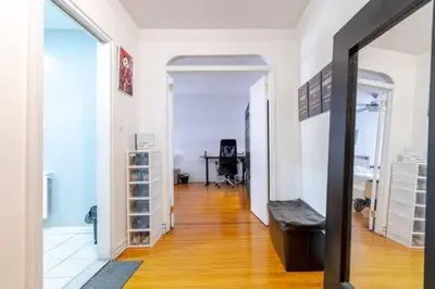 a room with a hallway with a table and a mirror at 2 Large Bedrooms In Rego Park in Rego Park