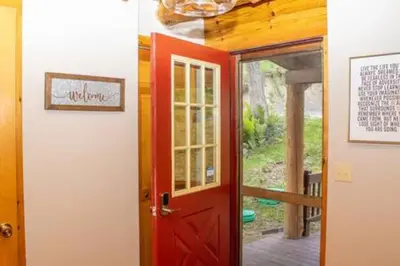a red door leading into a room with a doorway at Colgate Cabin #6 in Hamilton