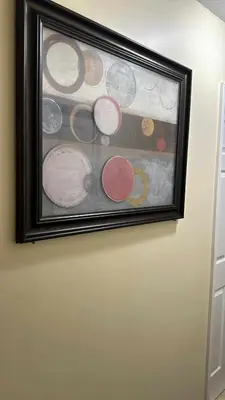 a framed painting of planets on a wall at Room J Divine Villa and Resorts 5mins to EWR Airport and 4mins to Penn Station Newark, New York in Newark