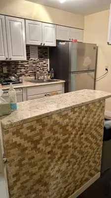 a kitchen with a counter top and a refrigerator at Room J Divine Villa and Resorts 5mins to EWR Airport and 4mins to Penn Station Newark, New York in Newark