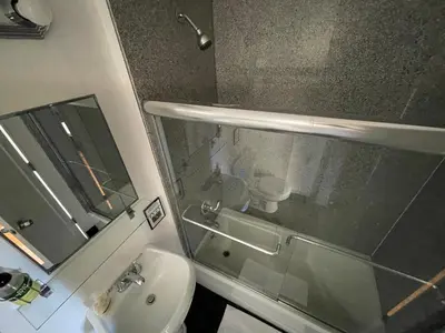 a bathroom with a sink and a toilet and a mirror at Nest aparthotel with kitchenette in New York
