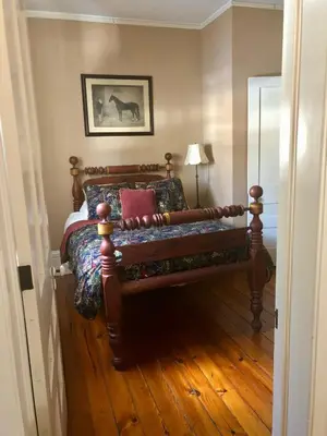 a bedroom with a bed with a wooden floor at Oakcliff Bed and Breakfast in Halfmoon