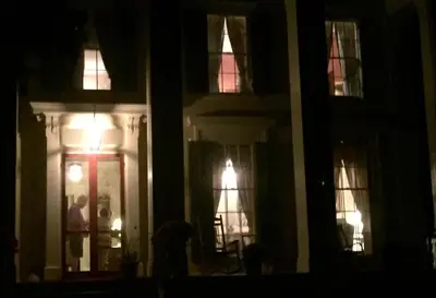 a dark room with windows and a door at night at Oakcliff Bed and Breakfast in Halfmoon