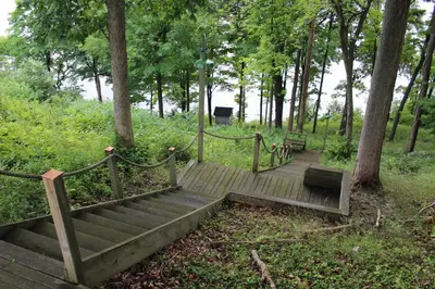 a wooden staircase in a park with two benches at Oakcliff Bed and Breakfast in Halfmoon
