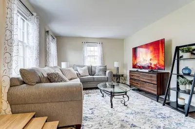 a living room with a couch and a tv at Family Gem on Dyer Street in New Haven