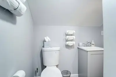 a white bathroom with a toilet and a sink at Family Gem on Dyer Street in New Haven