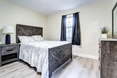 a white bedroom with a large bed and a window at Family Gem on Dyer Street in New Haven