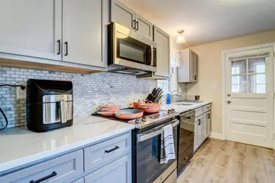 a kitchen with white cabinets and a microwave at Family Gem on Dyer Street in New Haven