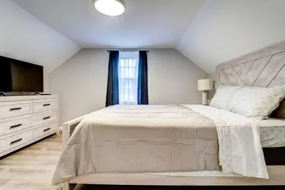 a bedroom with a large bed and a television at Family Gem on Dyer Street in New Haven