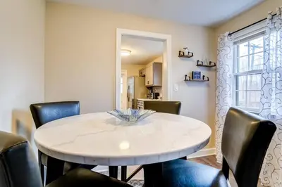 a dining room with a white table and chairs at Family Gem on Dyer Street in New Haven
