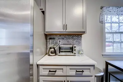 a kitchen with white cabinets and a blender on a counter at Family Gem on Dyer Street in New Haven