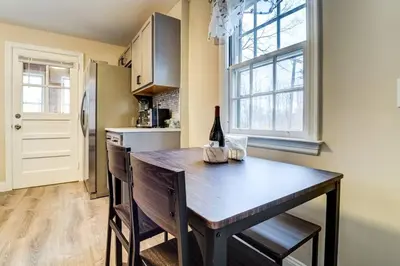 a kitchen with a wooden table with chairs and a refrigerator at Family Gem on Dyer Street in New Haven