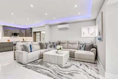 a living room with a couch and a table at Waterfront Lake Hopatcong Home with Boat Dock! in Mount Arlington