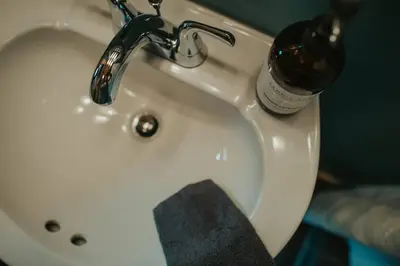 a white sink with a bottle of alcohol on it at Mountainscape: Peaceful & Skiing in Roxbury