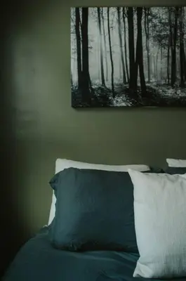 a bedroom with a bed with a picture on the wall at Mountainscape: Peaceful & Skiing in Roxbury