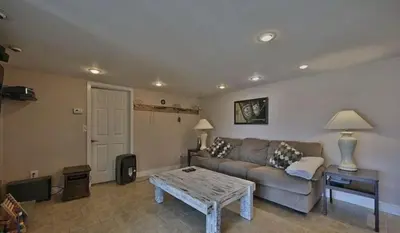 a living room with a couch and a coffee table at Hideaway - LakeHouse/spa/dock/ in Pocono Summit