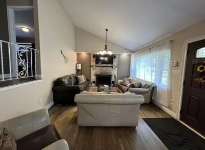 a living room with a couch and a fireplace at Hideaway - LakeHouse/spa/dock/ in Pocono Summit