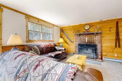 a living room with a couch and a fireplace at Little Bend Haven in Wilmington
