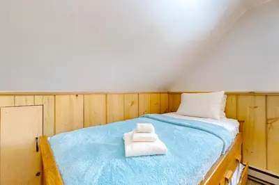 a room with a bed with two towels on it at Little Bend Haven in Wilmington