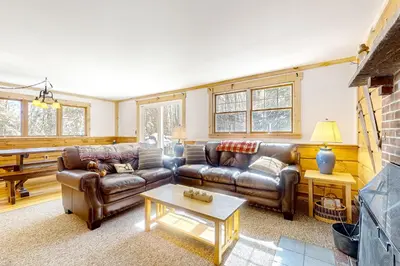 a living room with two leather couches and a table at Little Bend Haven in Wilmington