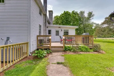 a deck with a table and chairs on a house at Historic Farmhouse in Layton with Deck! in Layton