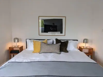 a bedroom with a large bed with pillows on it at Hudson River Cliff House in Saugerties