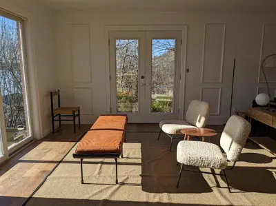 a living room with two chairs and a table at Hudson River Cliff House in Saugerties