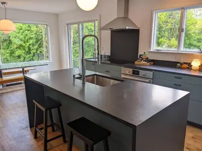 a kitchen with a large island in the middle of it at Hudson River Cliff House in Saugerties
