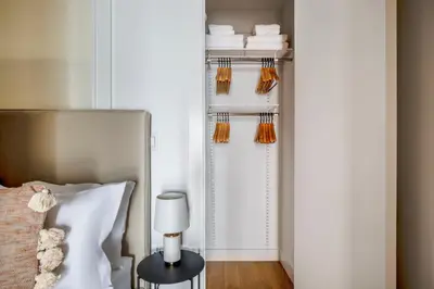 a bedroom with a bed and a table with a lamp at Classic LES 1br w wd nr SoHo NYC-646 in New York