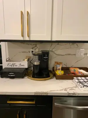 a kitchen counter with a coffee maker on a counter at Cityscape in Newark