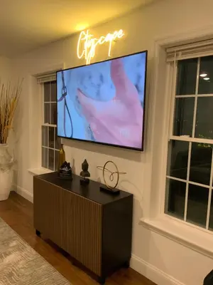 a living room with a flat screen tv on a wall at Cityscape in Newark