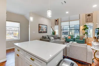 a kitchen and living room with a white counter top at Luxe Newark Retreat with Rooftop Deck Pets Welcome! in Newark