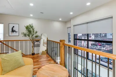 a living room with a couch and a balcony at Luxe Newark Retreat with Rooftop Deck Pets Welcome! in Newark