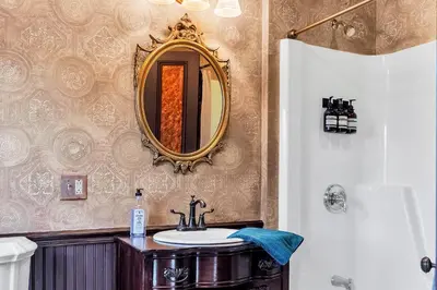 a bathroom with a sink and a mirror on the wall at Hot Tub and Large Yard Elegant Deansboro Getaway in Deansboro