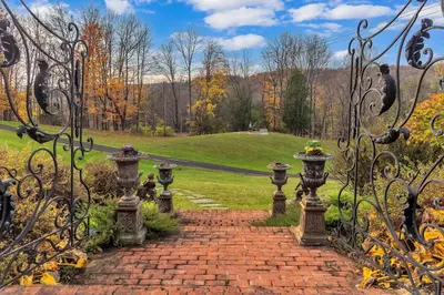 a brick path through the gates of a garden at Hot Tub and Large Yard Elegant Deansboro Getaway in Deansboro