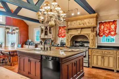 a large kitchen with a large center island with a fireplace at Hot Tub and Large Yard Elegant Deansboro Getaway in Deansboro