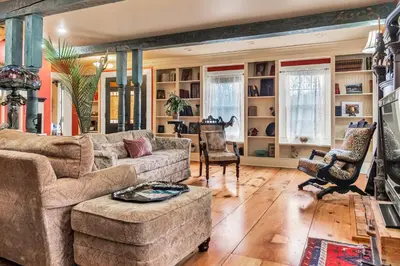 a living room with a couch and a chair at Hot Tub and Large Yard Elegant Deansboro Getaway in Deansboro
