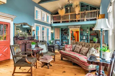 a living room with a couch and a table at Hot Tub and Large Yard Elegant Deansboro Getaway in Deansboro