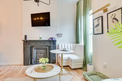 a living room with a fireplace and a table at Downtown Albany Vacation Rental - Chic and Walkable! in Albany