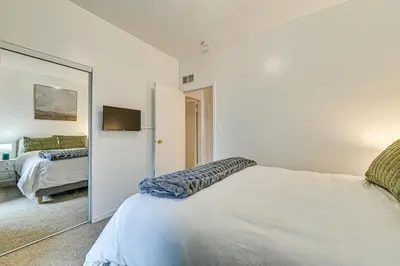 a bedroom with a bed and a mirror at Downtown Albany Vacation Rental - Chic and Walkable! in Albany