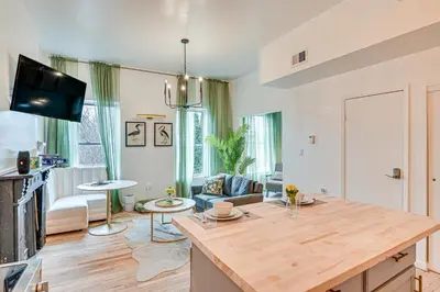 a kitchen and living room with a wooden counter top at Downtown Albany Vacation Rental - Chic and Walkable! in Albany